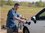 A person charging an electric vehicle - thumbnail