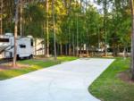 A paved RV site and picnic table at WOODLAND CREEK RV PARK - thumbnail