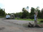 Open RV space near parked trailer at site Bear Ridge Campground & Cottages - thumbnail