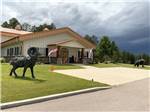 Bear and Ram statues in front of the office at CanAmerican 85 RV Park - thumbnail