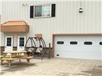 A patio swing and picnic table by the office at CanAmerican 85 RV Park - thumbnail