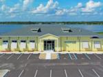 Exterior front of building with lake in the background at WATERSIDE RV RESORT - thumbnail