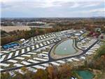 A view of the RV sites, pond and pickle ball courts at The Farm RV Resort - thumbnail