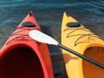 An orange and yellow kayak in the river at RIVER MEADOW CAMPGROUND - thumbnail