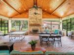 Interior of the rec hall with stone fireplace at FARM OF DREAMS RESORT - thumbnail