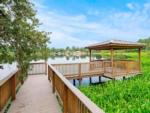 A pier leading to a gazebo on the water at FARM OF DREAMS RESORT - thumbnail