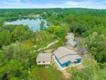 Aerial view of the property with buildings and lake at FARM OF DREAMS RESORT - thumbnail