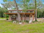 Exterior of a rental cabin with a porch at FARM OF DREAMS RESORT - thumbnail