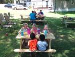 Little kids at a little picnic table at PINE RIDGE RV PARK - thumbnail