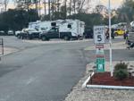 RVs at site and 5 mph sign at STEINHATCHEE VILLAGE RV PARK - thumbnail