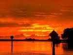 Orange and yellow sky at sunset at STEINHATCHEE VILLAGE RV PARK - thumbnail