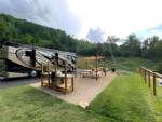 Parked RV with covered seating area at The Barlow RV Park - thumbnail