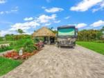 RV parked in lot with thatched canopy at LAGUNA CARIBE - thumbnail