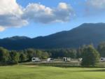 RVs across a grassy field at APPLEGATE RV RESORT - thumbnail