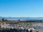 Rock wall next to picnic tables at COTTONWOOD SPRINGS RV RESORT - thumbnail