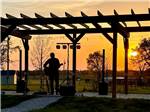 A man playing guitar under the pergola - thumbnail