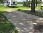 Open RV space near parked trailer at Birch Creek RV Park - thumbnail