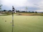 Putting green with flag and golf balls at GOPHER GULCH RV & CAMPGROUND - thumbnail