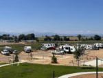 Parked RVs with mountains in background at GOPHER GULCH RV & CAMPGROUND - thumbnail