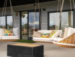 Porch of building with hanging chairs at GOPHER GULCH RV & CAMPGROUND - thumbnail