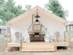 A white glamping tent with a deck at Timberline Glamping at Lake Guntersville - thumbnail