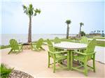 Tables and chairs with an ocean view at Firefly Resort Coastal Bend - thumbnail