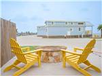 Two yellow chairs around a fire pit at Firefly Resort Coastal Bend - thumbnail