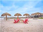 Umbrellas and chairs in the sand at Firefly Resort Coastal Bend - thumbnail