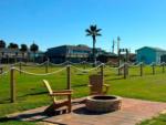 Adirondack chairs around a fire ring at SANDOLLAR RV PARK - thumbnail