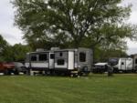 RVs parked in grassy sites at OUR FRIENDS CAMPGROUND - thumbnail