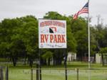 The park sign and an American flag at OUR FRIENDS CAMPGROUND - thumbnail