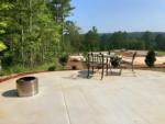 Table and chairs near a fire pit at TALKING ROCK MOTORCOACH RESORT - thumbnail