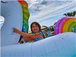 A young girl on a floaty in the pool at LHTX RV Resort - thumbnail