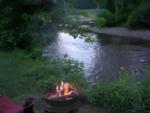 Fire pit in front of creek at site Onion River Campground - thumbnail