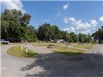 Gravel RV sites with hookups and picnic tables at Old Florida RV Resort - thumbnail