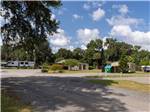 A gravel road leading to buildings and RV sites at Old Florida RV Resort - thumbnail