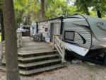 Travel trailer parked at a site with a porch at Big Foot Resort - thumbnail