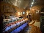 A rental cabin bedroom at The Woods RV and Cabin Resort - thumbnail