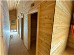 Interior of cabin hallway with rooms on the side at Ptimaster RV Park - thumbnail