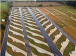 Aerial view of pull thru concrete sites with paved roads at Summer Breeze RV Park - thumbnail