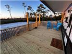 A wooden deck next to a parked RV - thumbnail