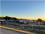 RVs parked in sites at sunset at Waterfront Hideaway Ranch - thumbnail
