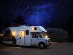 An RV at site on a starry night at I-55 RV Park & Campground - thumbnail