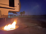 A fire ring near an RV at site at Holly Beach RV Park - thumbnail