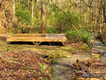 A wood tent platform near the creek at Gorgeous Stays - thumbnail
