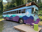 A brightly painted rental bus at Gorgeous Stays - thumbnail