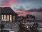 People around a fire ring at sunset at Outdoorsy Hill Country - thumbnail