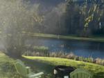 Chairs near fire pit and lake at site Route 6 Campground - thumbnail