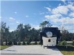 A travel trailer parked in a back-in site - thumbnail