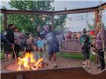 People having fun around a community fire pit - thumbnail